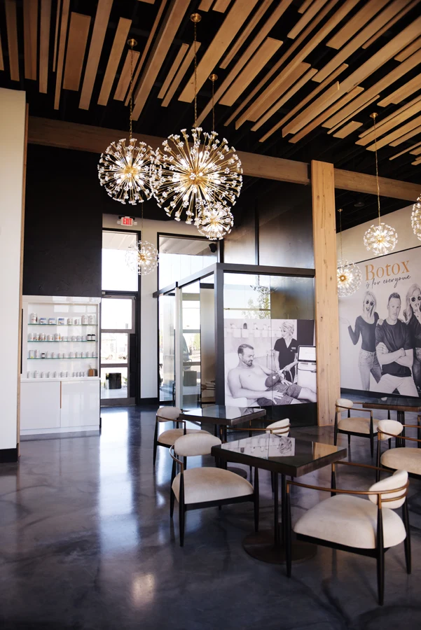 Central Wellness lounge with sculptural chandeliers and timber ceiling
